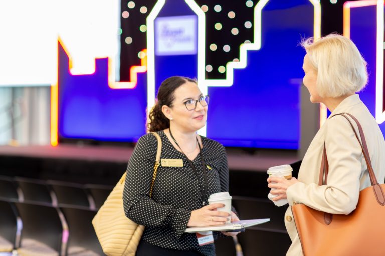 two women smile during conversation