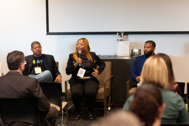 image of three people - two men and a woman - speaking to a group of people at Avant South